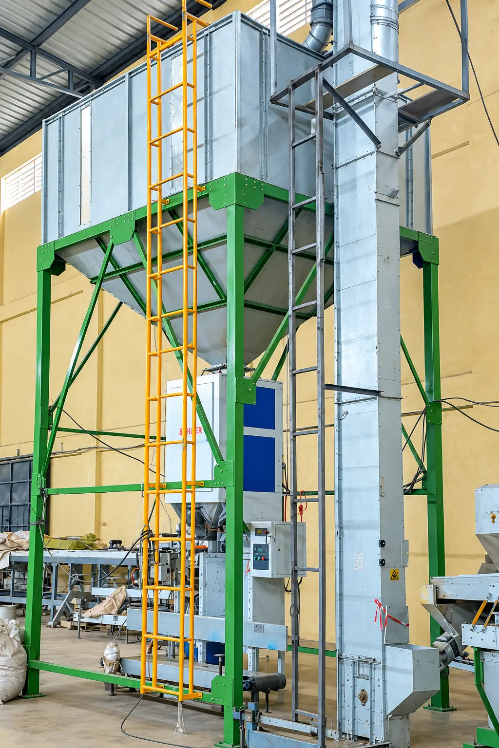 Green steel bagging hopper with gravity weigher and bucket elevator