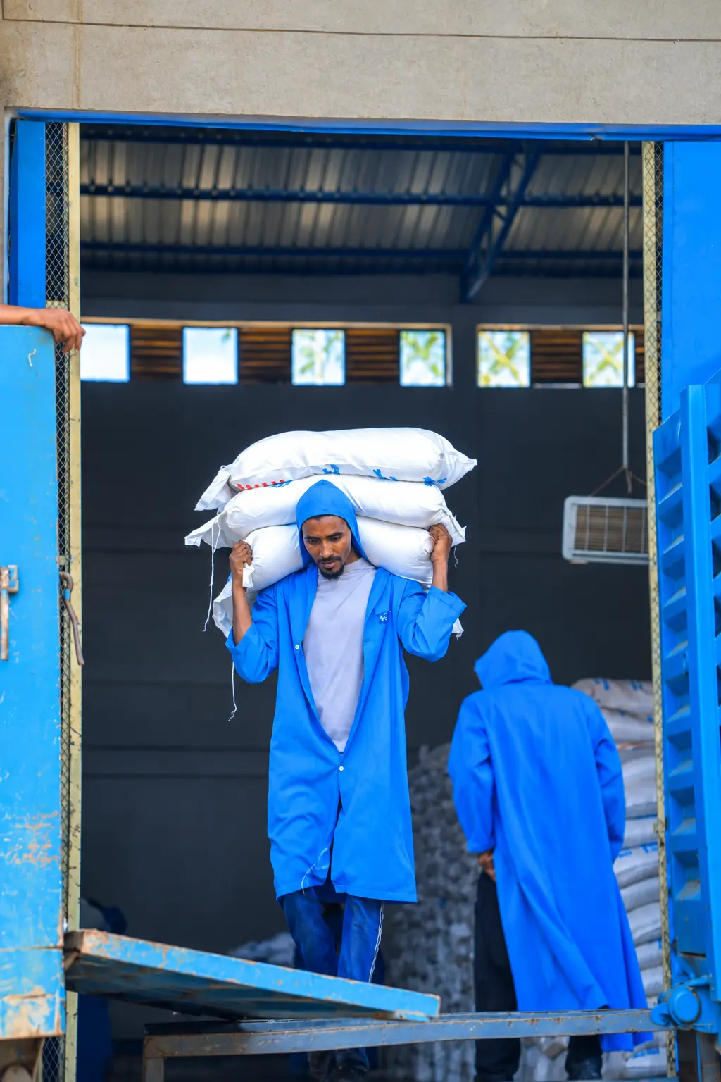 Quarit workers moving packaged products from a loading bay